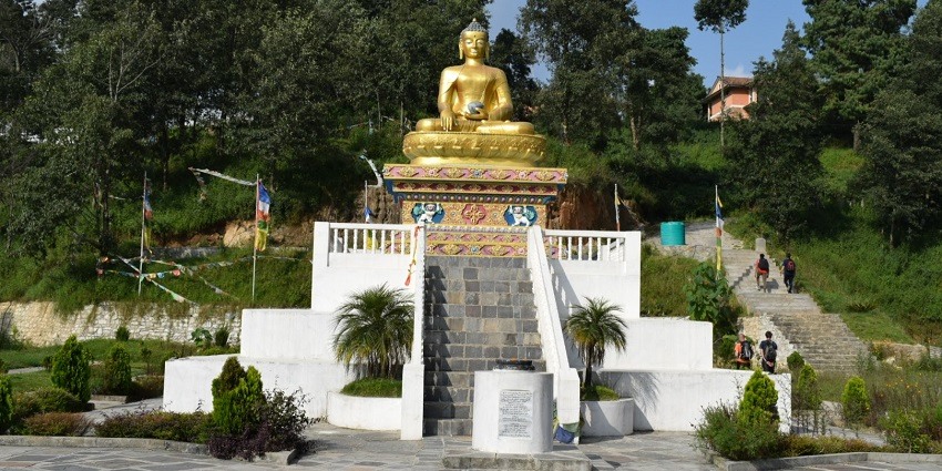 A picture of a Buddha temple with a statue of Buddha on top, one of the best places to visit in Nepal in June