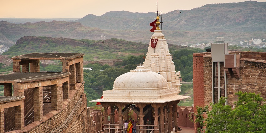 View of the temple, with densely forested hills in the background