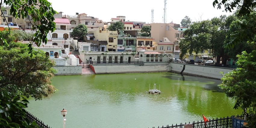 Rani Tal in Nahan, Himachal Pradesh, surrounded by lush greenery and a tranquil water surface reflecting the sky