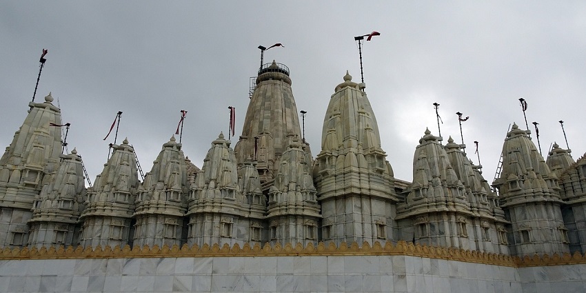 Landscape picture of the ancient Nakoda Jain Temple, against the cloudy sky