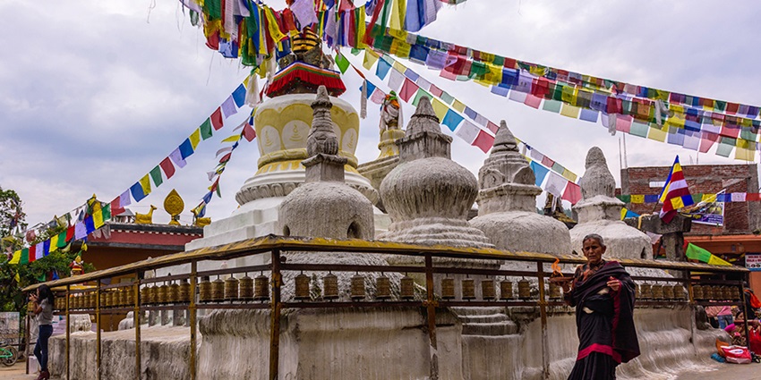 The Namo Buddha Stupa, a sacred Buddhist site, sits atop a hill overlooking a serene landscape.