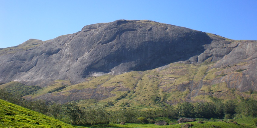 A mountain surrounded with greenery, like the Nandan Pahar near Babadham Temple.