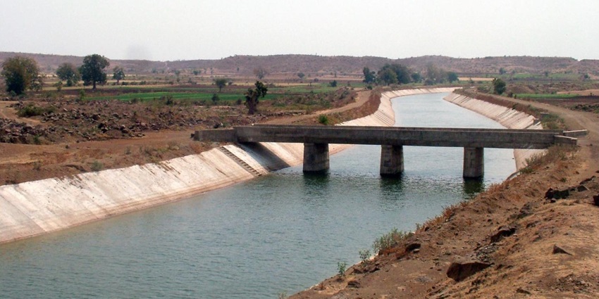 Narmada Canal flowing through a scenic landscape with clear skies and lush greenery