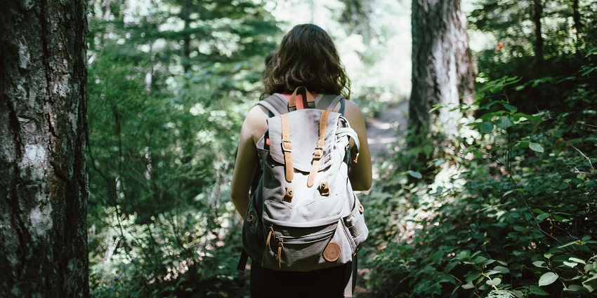 An image of a woman walking through nature at the famous Karlapat Wildlife Sanctuary.