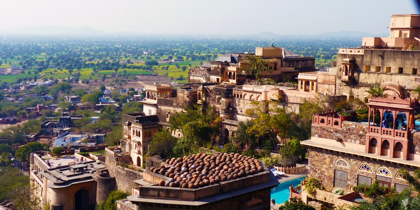 A glimpse of the splendid fortress of Neemrana surrounded by lush green vegetation.