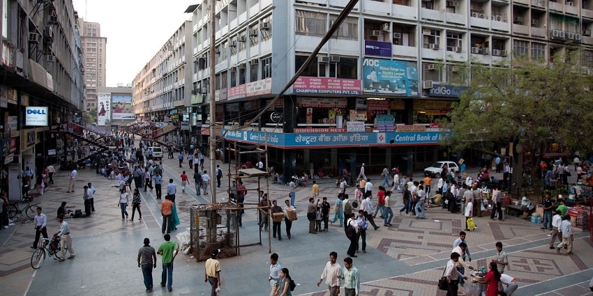 Nehru Place metro station in Delhi, showcasing modern architecture and commuters.
