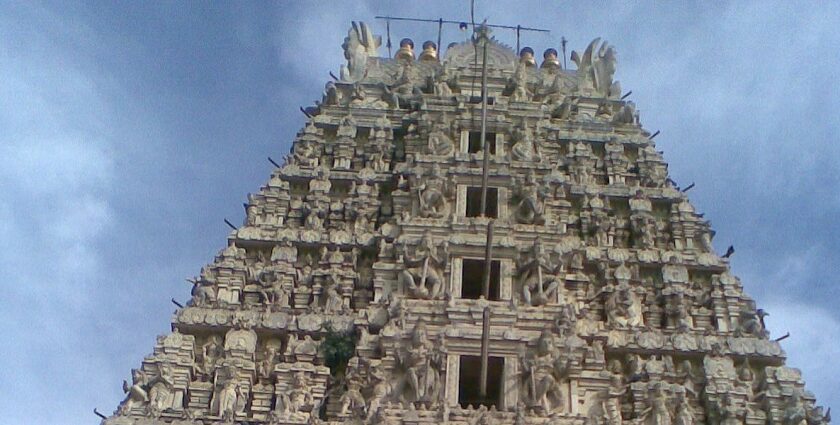 A picture of a temple taken from a distance with greenery and trees surrounding it