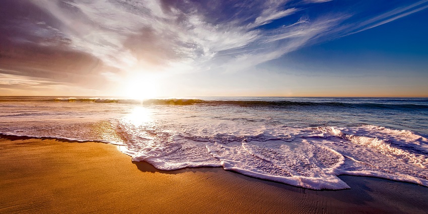 Image of sea shore amidst beautiful sunset and picturesque sky
