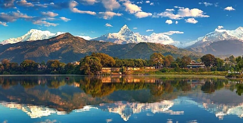 A stunning view of lake and Himalayan peaks in Nepal–perfect spot for Nepal Music Festival