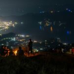 Vibrant night street view of Kathmandu with cars, bustling Nepal nightlife for singles.