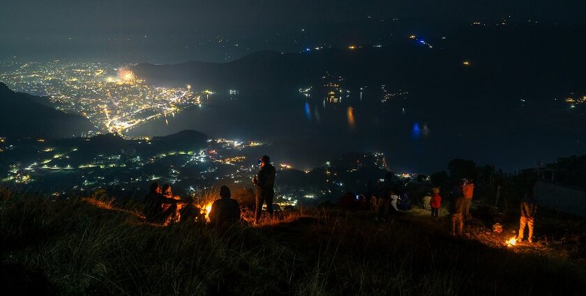 Vibrant night street view of Kathmandu with cars, bustling Nepal nightlife for singles.