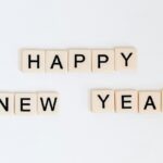 An amazing view of small scrabbles saying happy new year against a plain white surface.