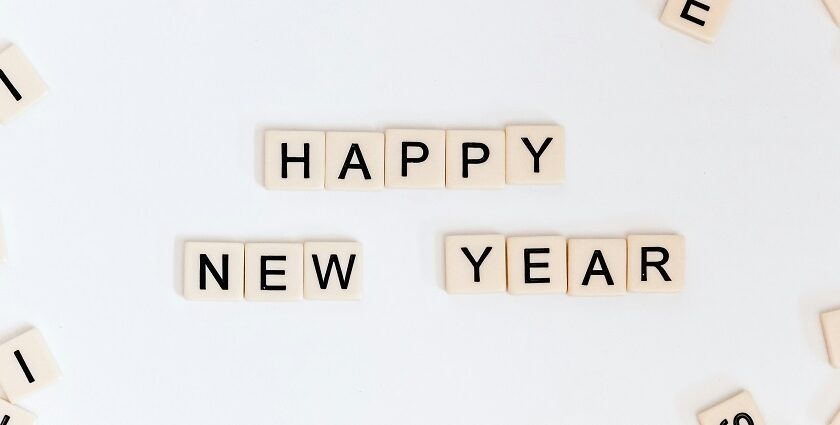 An amazing view of small scrabbles saying happy new year against a plain white surface.