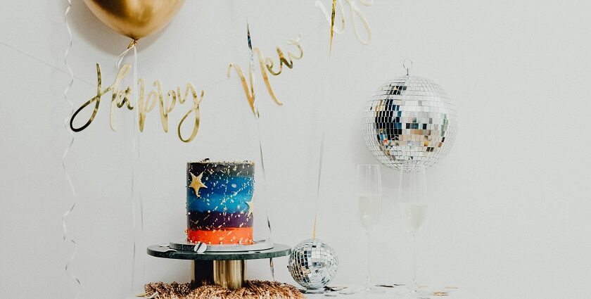 A glimpse of disco ball, balloon, and a cake on a table for celebrations in Rajasthan.