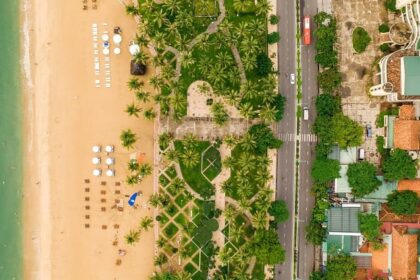 A bird’s eye view of the region from the sea showcasing cityscape and serene coastline.