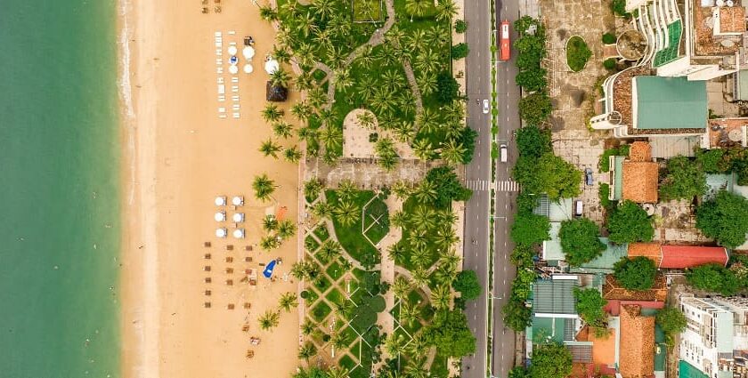 A bird’s eye view of the region from the sea showcasing cityscape and serene coastline.