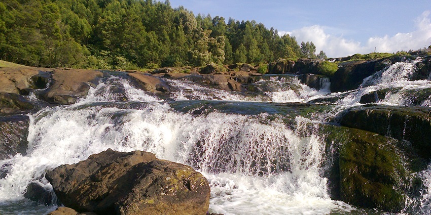 Nilgiri Waterfall of Orissa cascades gently through the emerald hills.