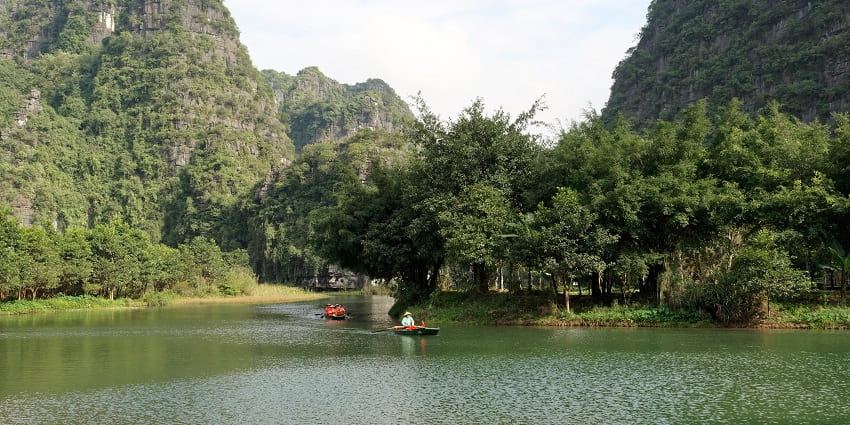 Trang An's scenic karst landscape with lush greenery and tranquil waterways, Ninh Binh