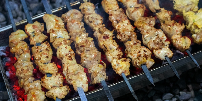 Delicious chicken kebabs on a grill, one of the famous delicacies for Mughlai cuisine lovers
