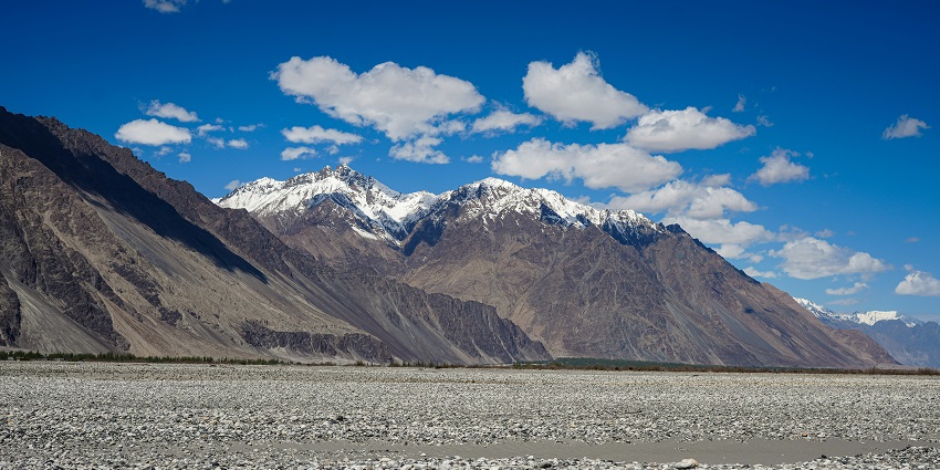 A mesmerising view of the Nubra Valley with stunning snow-capped mountains in the day.
