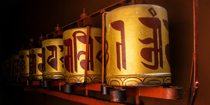 Image of Buddhist Prayer Wheels in Dimly Lit Temple -
Observe Prayer Wheels