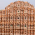 Hawa Mahal in Jaipur, featuring its iconic red and pink sandstone structure with numerous small jharokhas