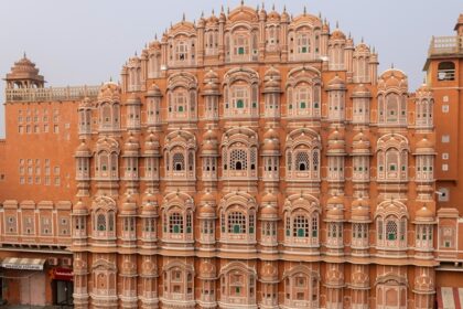 Hawa Mahal in Jaipur, featuring its iconic red and pink sandstone structure with numerous small jharokhas