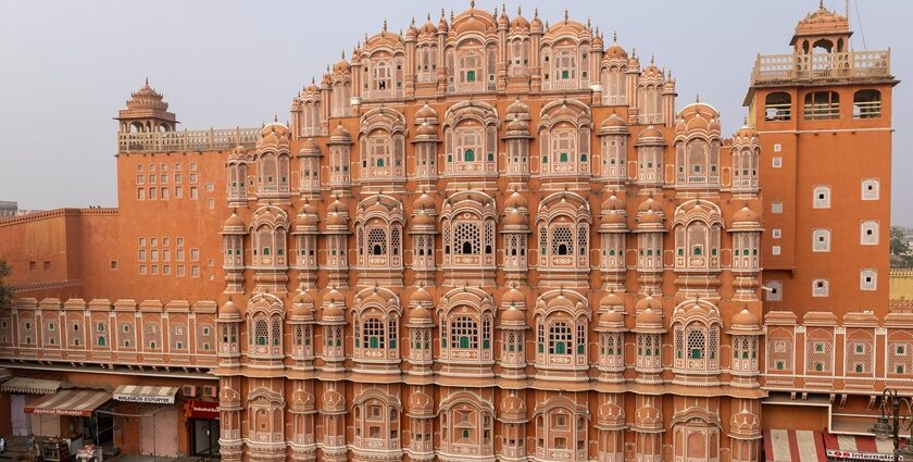 Hawa Mahal in Jaipur, featuring its iconic red and pink sandstone structure with numerous small jharokhas