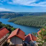 A breathtaking view of red and white houses near a sparkling body of water during the day.