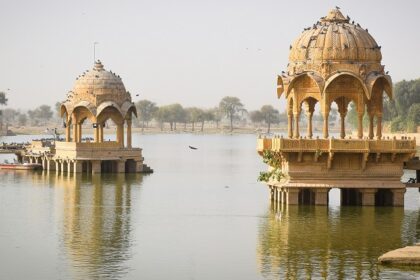 A scenic view of a fort standing elegantly amidst the azure waters with a quaint backdrop.