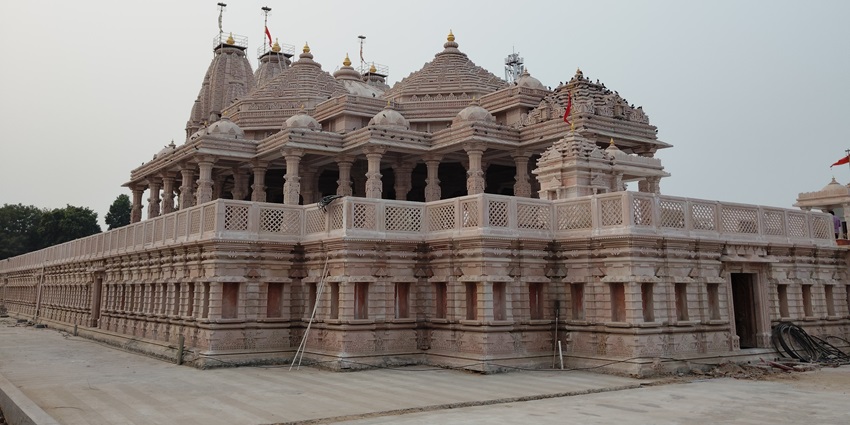 A sacred temple atop a hill with a natural water stream flowing over the Shiva Lingam.