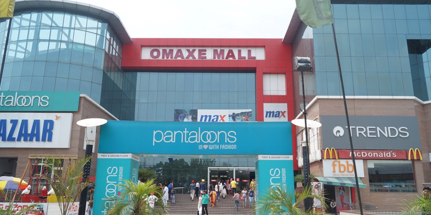 Front façade of Omaxe Mall Patiala with modern glass panels, signage, and spacious pedestrian forecourt