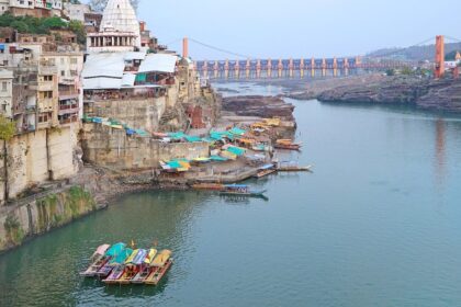 View of the Narmada River near Omkareshwar Temple, showcasing the river's flow and temple backdrop.