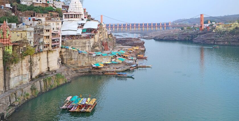 View of the Narmada River near Omkareshwar Temple, showcasing the river's flow and temple backdrop.