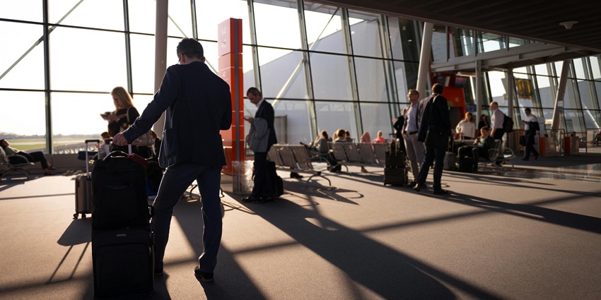 Image of people waiting inside the airport for their flights with luggages and family members