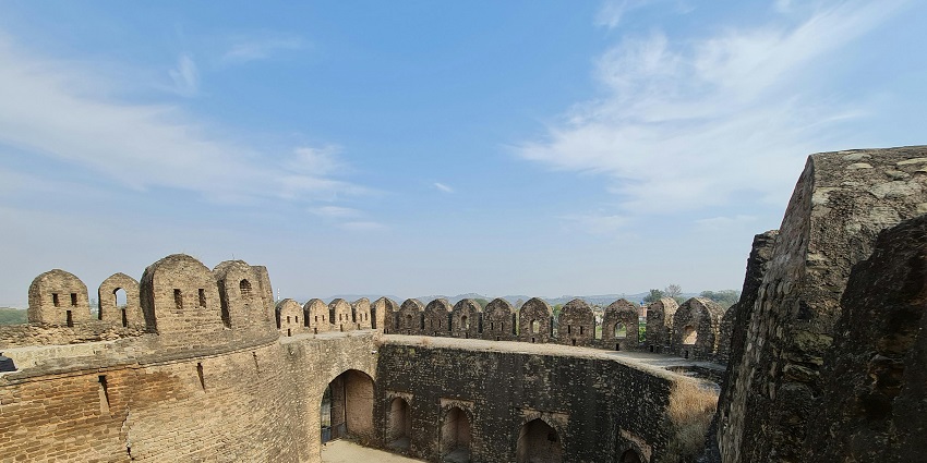 Picturesque view of old stone castle on blue sky, showcasing historical significance