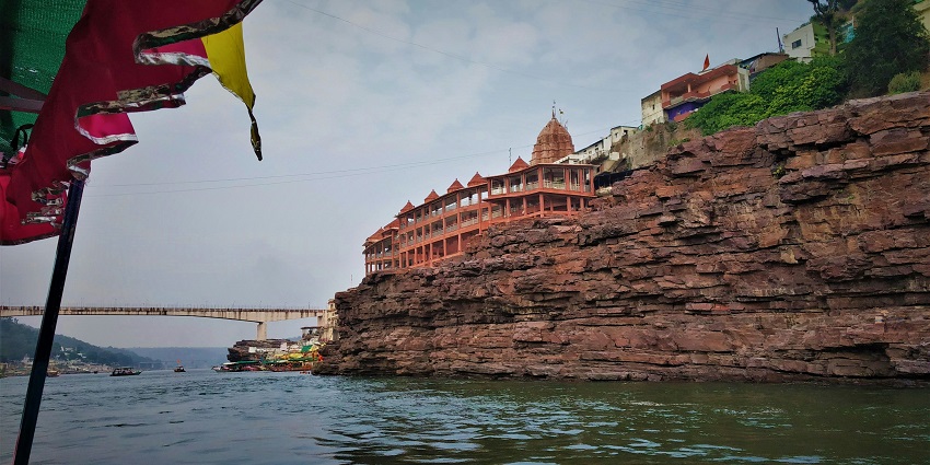 View the tourist attraction near the Omkareshwar Temple with the Narmada River and riverbank scenery.