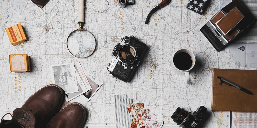 An image of a map, a camera and other travel things necessary for your trip to Ajmer.