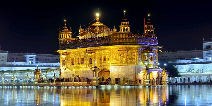 Beautiful image of the temple scintillating in the scenic setting of Amritsar and its scared pond