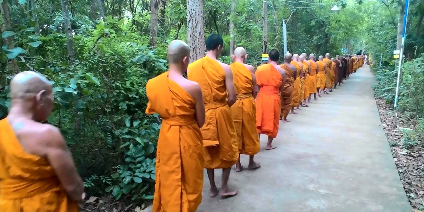 Buddhist monks walking in a queue to the Jirang Monastery through the hills