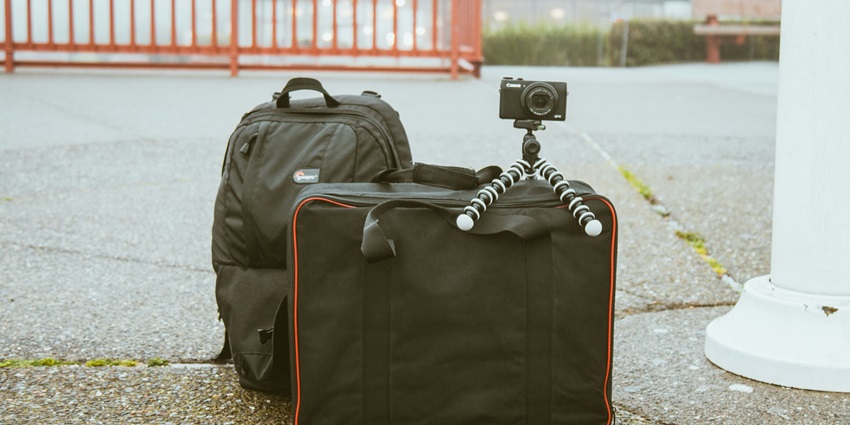 Image of backpacks and a tripod camera on the bag for travelling - explore the museums in Delhi