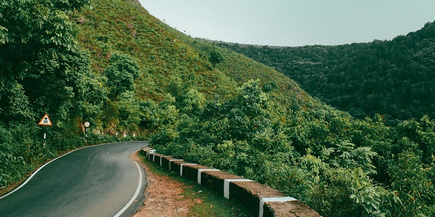 Picturesque view of road to Araku Valley surrounded by lush greenery hills and twisty roads during day time