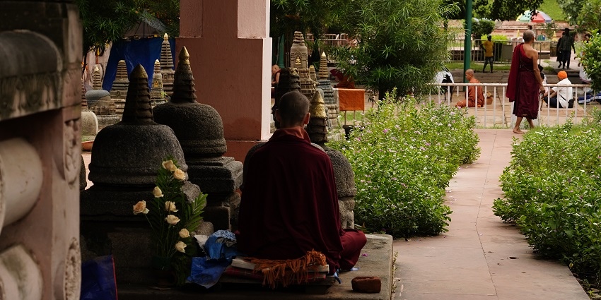 Rows of ancient votive stupas within the Mahabodhi Temple complex and monks praying.
Viewers of this file can see comments and suggestions
