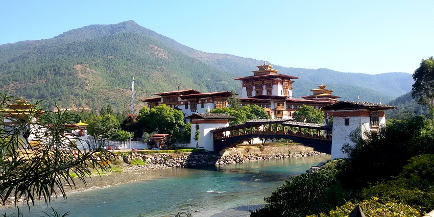 A captivating landscape of Bhutan, featuring majestic mountains, dense forests, and a winding river, highlighting the natural wonders.