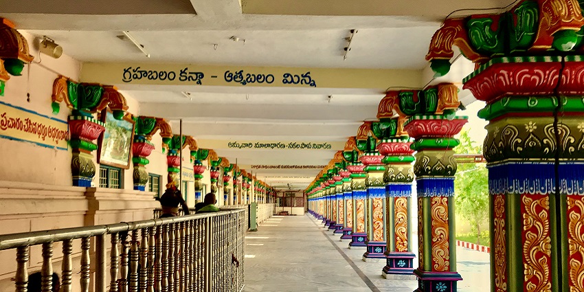 Corridor in Penuganchiprolu Temple featuring intricate carvings and traditional design elements