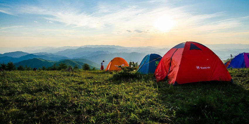 Image of tents near the mountains with serene view and sunrise one can enjoy