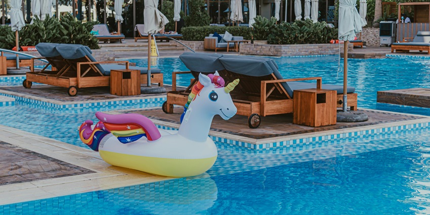 Child joyfully playing with colourful inflatable, enjoying endless fun at Water Park