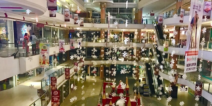 PVP Square Mall has a glassy modern outlook with large signs and decorations.