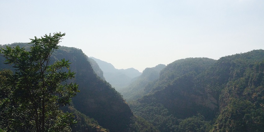 Panoramic view of Pachmarhi Valley, showcasing lush greenery and rolling hills.