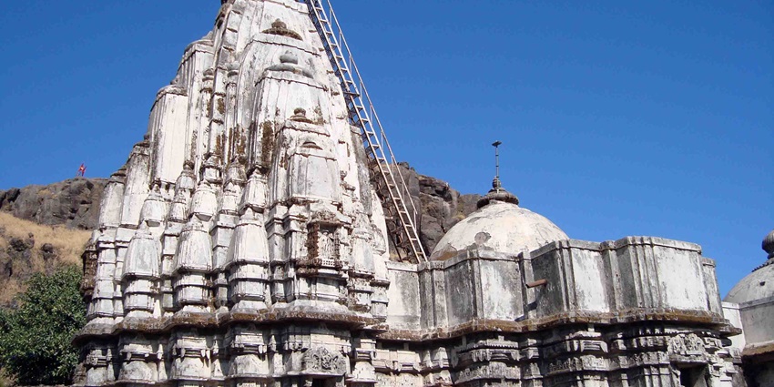 Image of an ancient temple near the hills - one of the best temples to visit in Gujarat
